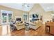 Bright living room with a vaulted ceiling, fireplace, and comfortable seating at 3480 Indian Shoals Rd, Dacula, GA 30019