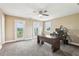 Spacious office with two French doors, large desk, ceiling fan, and carpeted flooring at 3480 Indian Shoals Rd, Dacula, GA 30019