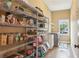 Walk-in pantry with wire shelves, laundry area, and a window letting in natural light at 3480 Indian Shoals Rd, Dacula, GA 30019