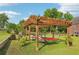 Green backyard featuring a pergola with cozy seating and a hammock for relaxation at 3480 Indian Shoals Rd, Dacula, GA 30019