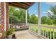 Relaxing porch featuring a comfortable swing and serene backyard views at 3480 Indian Shoals Rd, Dacula, GA 30019