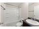 This is a full bathroom with a shower over tub, a dark vanity, and neutral decor at 403 Sonja Ln, Loganville, GA 30052