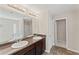 Bathroom featuring a double sink vanity, two mirrors, and tiled floors at 403 Sonja Ln, Loganville, GA 30052