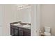 Bathroom featuring a double sink vanity, two mirrors, and a toilet at 403 Sonja Ln, Loganville, GA 30052