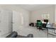 This bedroom is staged with a desk and computer and has three doors, one to a closet and one to a bath at 403 Sonja Ln, Loganville, GA 30052
