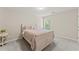 Bedroom featuring a window and bed with colorful patterned linens at 403 Sonja Ln, Loganville, GA 30052