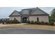 Attractive clubhouse with stone accents, arched entry, and neatly manicured landscaping at 403 Sonja Ln, Loganville, GA 30052