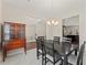 Elegant dining room with hardwood floors, a chandelier, and an open view into the living room at 403 Sonja Ln, Loganville, GA 30052