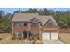 Beautiful two-story brick home with a two-car garage and meticulously kept landscaping at 403 Sonja Ln, Loganville, GA 30052