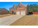 Impressive two-story home with a brick facade, attached two-car garage, and a well-manicured lawn at 403 Sonja Ln, Loganville, GA 30052
