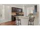 This is a spacious kitchen with granite counters, dark cabinets, stainless appliances, and a breakfast bar at 403 Sonja Ln, Loganville, GA 30052