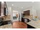 Modern kitchen featuring stainless steel appliances, granite countertops, and dark wood cabinets at 403 Sonja Ln, Loganville, GA 30052
