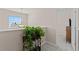 This is an upstairs hallway showing a plant on a table by a window and an open doorway to a bedroom at 403 Sonja Ln, Loganville, GA 30052