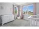 Bright Bedroom with a modern dresser and a white crib at 710 Elmwood Way, Roswell, GA 30075