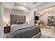 Finished basement bedroom with comfortable bed adjacent to the living room area at 710 Elmwood Way, Roswell, GA 30075