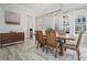 Inviting dining room with wooden table, modern lighting, and sun-filled windows at 710 Elmwood Way, Roswell, GA 30075
