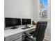 Functional home office with built-in desk, comfortable seating, and ample natural light at 710 Elmwood Way, Roswell, GA 30075