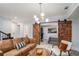 Finished basement with exposed barn door, modern light fixture and comfortable seating at 710 Elmwood Way, Roswell, GA 30075