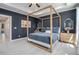 Serene main bedroom featuring a luxurious four-poster bed, tray ceiling, and soft lighting at 710 Elmwood Way, Roswell, GA 30075