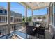 Relaxing covered patio with fire pit, dining table, grill, and outdoor seating perfect for entertaining at 710 Elmwood Way, Roswell, GA 30075