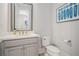Stylish powder room featuring a modern vanity, elegant mirror, and fresh decor at 710 Elmwood Way, Roswell, GA 30075