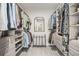 Spacious walk-in closet with custom shelving, drawers, and a dressing mirror at 710 Elmwood Way, Roswell, GA 30075
