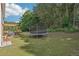 Spacious green backyard features an outdoor pergola and a trampoline for recreational enjoyment at 1017 Preserve Park Dr, Loganville, GA 30052