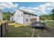 A large backyard with green grass, a wooden fence, pergola, and a trampoline at 1017 Preserve Park Dr, Loganville, GA 30052