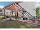 Cozy backyard patio with a pergola, comfortable seating, and a fire pit area for outdoor enjoyment at 1017 Preserve Park Dr, Loganville, GA 30052