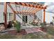 Outdoor patio with pergola, lounge chairs, and lush landscaping, perfect for relaxation at 1017 Preserve Park Dr, Loganville, GA 30052