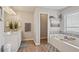 Bright bathroom featuring a soaking tub, walk-in shower, and single vanity at 1017 Preserve Park Dr, Loganville, GA 30052