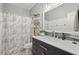 Bathroom with a white marble countertop, gray tile backsplash, and a decorative shower curtain at 1017 Preserve Park Dr, Loganville, GA 30052