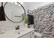 Modern bathroom with a stylish mirror, a patterned shower curtain, and elegant fixtures at 1017 Preserve Park Dr, Loganville, GA 30052