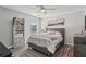 Cozy bedroom with a tufted headboard, wood floors, and storage shelves at 1017 Preserve Park Dr, Loganville, GA 30052