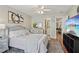 Bright bedroom with an upholstered headboard, wood floors, and view to bath and home office at 1017 Preserve Park Dr, Loganville, GA 30052