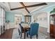 Elegant dining room with wainscoting, chandelier, and views into the modern kitchen at 1017 Preserve Park Dr, Loganville, GA 30052