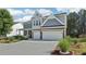 Charming two-story home with blue shutters and a well-manicured lawn and garden at 1017 Preserve Park Dr, Loganville, GA 30052