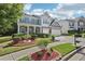 Two-story home with blue shutters, covered porch, brick accents, and a well-landscaped front yard at 1017 Preserve Park Dr, Loganville, GA 30052