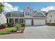Charming home featuring a landscaped front yard and a two-car garage at 1017 Preserve Park Dr, Loganville, GA 30052