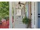 Cozy front porch with rocking chairs, ceiling fan, and a decorative blue door, perfect for relaxing at 1017 Preserve Park Dr, Loganville, GA 30052
