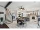 Open-concept kitchen and dining area featuring marble tile flooring, stairs, and a beamed ceiling at 1017 Preserve Park Dr, Loganville, GA 30052