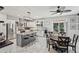Bright, open kitchen featuring a large island with seating, white cabinets, and stainless steel appliances at 1017 Preserve Park Dr, Loganville, GA 30052
