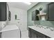 Well-organized laundry room with a folding counter, storage cabinets, and modern washer/dryer units at 1017 Preserve Park Dr, Loganville, GA 30052
