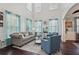 Bright living room with high ceilings, hardwood floors, and large windows with lots of natural light at 1017 Preserve Park Dr, Loganville, GA 30052