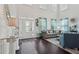 Elegant living room with high ceilings, hardwood floors, and a view of the front entrance at 1017 Preserve Park Dr, Loganville, GA 30052