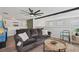 Open living space with a comfortable sofa, games, and modern ceiling fan, perfect for relaxing and entertaining at 1017 Preserve Park Dr, Loganville, GA 30052