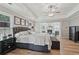 Spacious bedroom with a ceiling fan, tray ceiling, fireplace, and sitting area for relaxing at 1017 Preserve Park Dr, Loganville, GA 30052