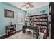 Home office with custom shelving, a spacious desk, and a comfortable rug at 1017 Preserve Park Dr, Loganville, GA 30052