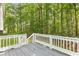 Outdoor back deck area featuring lush trees and white railing at 127 Danielle Ct, Villa Rica, GA 30180