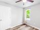 This bedroom includes wood-look floors, neutral walls, a ceiling fan, and a window at 127 Danielle Ct, Villa Rica, GA 30180